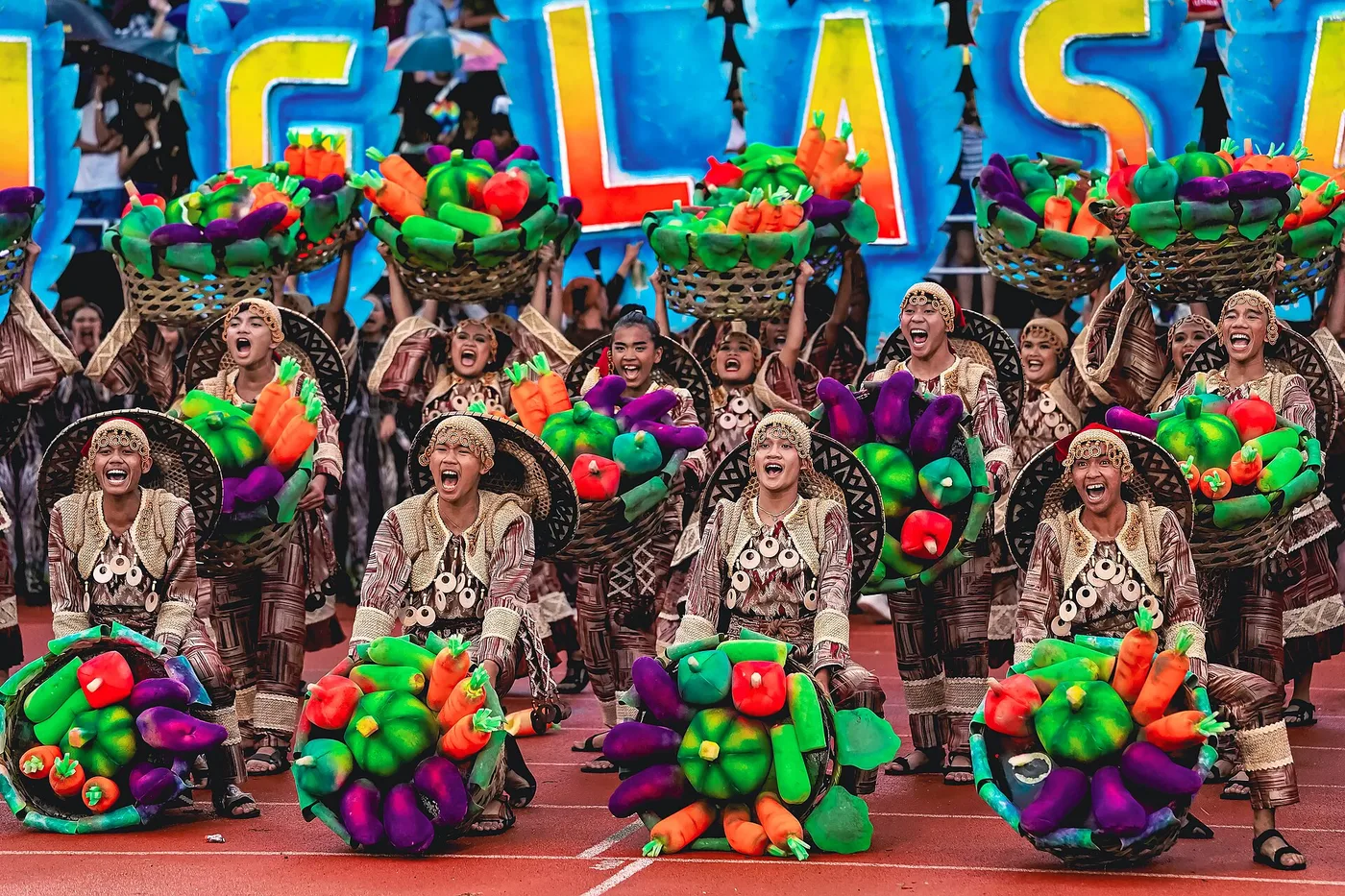 Buglasan Festival street dancers in Dumaguete in colourful harvest-themed costumes with vegetable headdresses
