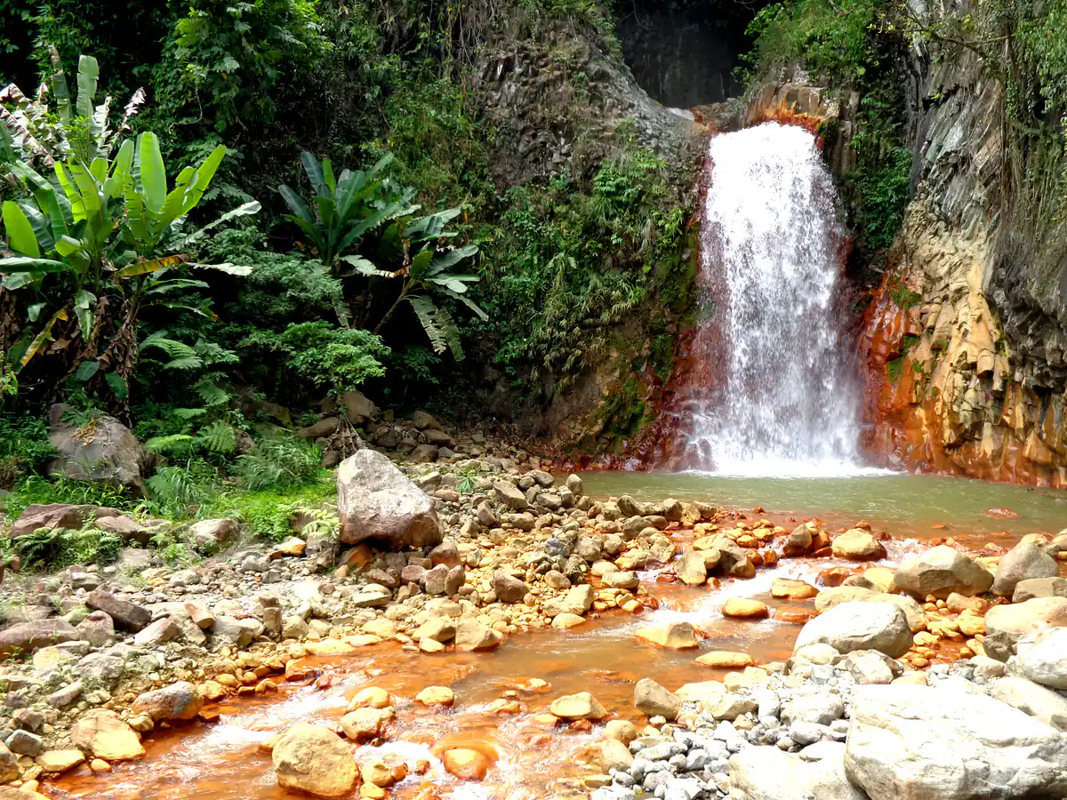 Pulangbato Falls tumbling over red mineral-stained rocks in Valencia, Negros Oriental
