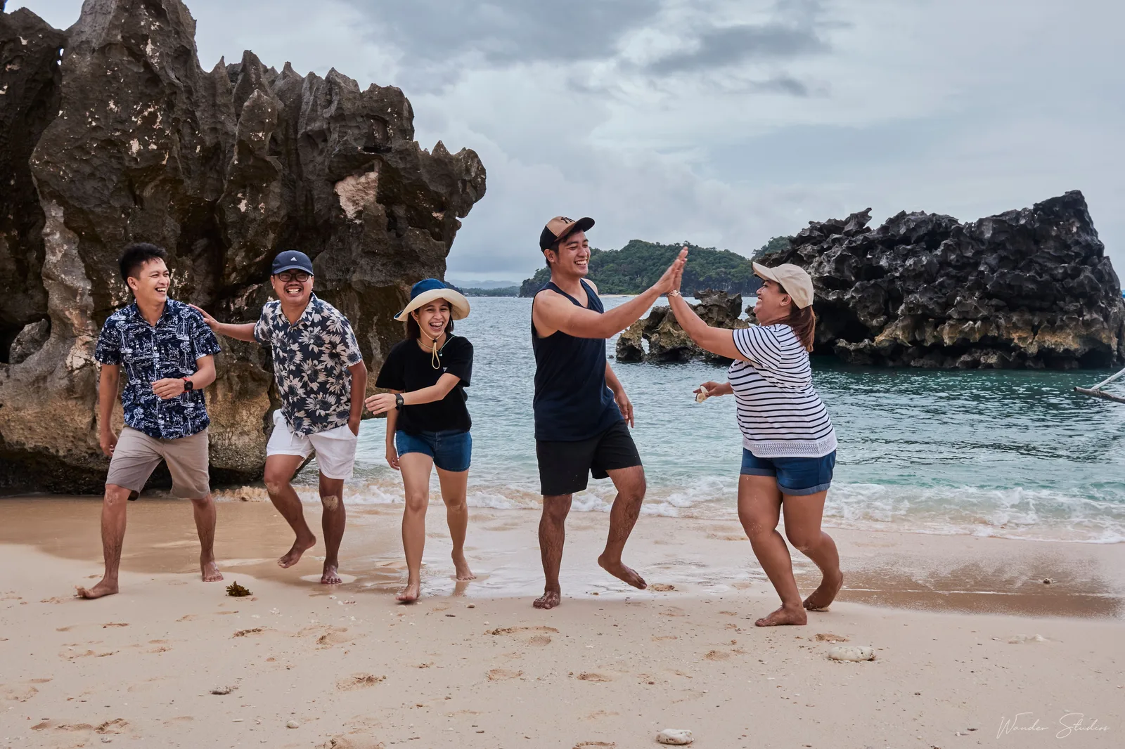 A group of friends laughing together on a Philippine beach